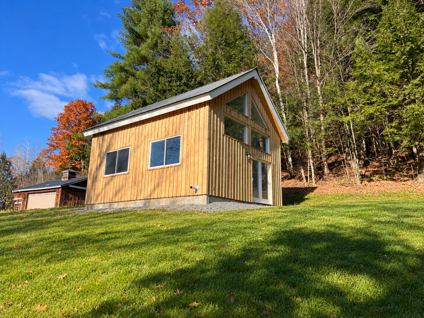 Tunbridge ADU — Exterior with natural wood siding and metal roof